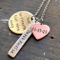 "Your First Breath Took Mine Away personalized with child's name necklace. 1 1/2\" solid silver alkeme stamped charm with brushed satin finish and beveled edge and your personalized name in script font. 5/8\" copper heart charm with birthdate. 1\" brass round stamped disc with quote \"Your first breath took mine away\" in modern font. Hangs from a .925 sterling silver chain and is hypo-allergenic and nickel free. *Please leave name and date you would like stamped in the personalization box with Personalized Pink Jewelry For Father's Day, Personalized Dog Tag Charm Necklace For Anniversary, Personalized Dog Tag Charm Necklaces For Anniversary, Mother's Day Stamped Charm Necklace As Personalized Gift, Stamped Jewelry For Valentine's Day Keepsake, Engraved Dog Tag Jewelry For Birthday, Valentine's Day Keepsake Stamped Jewelry, Hand Stamped Nameplate Jewelry For Anniversary Gift, Hand Stamped Nameplate Jewelry For Anniversary