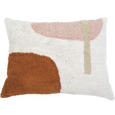 a white and brown pillow with an abstract design