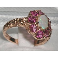 *This flower ring is made from 585 14K Rose Gold with Genuine Natural Semi-precious Opal & Pink Tourmalines.Like all my jewelry pieces, this ring is made in my own workshop. PLEASE MAKE SURE YOU STATE THE FINGER SIZE YOU REQUIRE WITH YOUR PAYMENT AND ALSO INCLUDE YOUR TELEPHONE NUMBER FOR DELIVERY COURIER.A beautiful Opal & Pink Tourmaline Ring set with a center 7x5mm (0.28"x0.20") Opal & eight 3.25mm (0.13" inches) vibrant Pink Tourmalines in a stylish Victorian Style cluster settin Pink Oval Multi-stone Ruby Ring, Fine Jewelry Pink Multi-stone Jewelry, Pink Ruby Rings With Multi-stone Detail, Elegant Pink Multi-stone Rings, Exquisite Pink Round Rings, Pink Ruby Ring With Gemstone Accents, Heirloom Pink Jewelry With Center Stone, Pink Multi-stone Cluster Ring As A Gift, Exquisite Pink Gemstone Rings