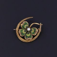 Antique Horseshoe Clover Brooch: This 14k gold brooch (circa 1915-1920) features an enamel clover with a pearl accent nestled inside a horseshoe.  The brooch bears the makers mark for the renowned Krementz & Co. of Newark, NJ.  The piece measures 0.8 inches by 0.8 inches wide and weighs 2.84 grams. It is in great condition. Upon purchase, your brooch will arrive elegantly packaged, ready for gifting or as a special treat for yourself.  We carefully wrap each piece to ensure a delightful unboxing experience. We also offer free and flexible layaway plans, so take advantage of this option to make owning your dream piece even more achievable. + Trademark Antiques Shop Homepage https://www.etsy.com/shop/TrademarkAntiques + Our Store Policies https://www.etsy.com/shop/TrademarkAntiques/policy?re Clover Brooch, Clover Jewelry, Newark Nj, Bespoke Rings, Gold Brooch, Locket Charms, Gold Brooches, Antique Shops, Locket Necklace