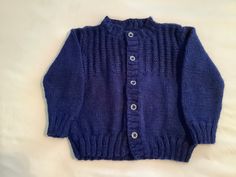 "Hand knit girls size 8 royal blue cardigan sweater. Detailed stitches at yoke front and back.   Loose fit.   13\" across front at underarms, 14\" from shoulder to hem and sleeves measuring 14\" from shoulder to cuff. Soft acrylic fiber."