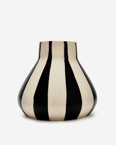 a black and white vase sitting on top of a table