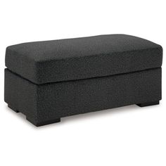 a black ottoman sitting on top of a white floor