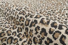 an animal print fabric with brown and black spots