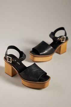 Leather upper Microsuede insole Wood heel Rubber sole Buckle styling Imported | Groove Platform Sandals by Kelsi Dagger Brooklyn in Black, Women's, Size: 8.5, Leather/Rubber/Suede at Anthropologie High Heel Suede Sandals With Leather Sole, Chic Leather Clogs With Ankle Strap, Suede Open Heel With Heel Loop, Suede Open Heel Shoes With Heel Loop, Suede Sandals With Heel Strap For Summer, Summer Suede Sandals With Heel Strap, Summer Round Toe Heels With Leather Sole, Chic Black Slingback Sandals With Wooden Heel, Closed Toe Suede Sandals With Heel Strap