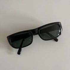 These rectangle sunglasses are your everyday classic.  Featuring a black frame with black tint lens.  This style is unisex.   True genuine vintage sunglasses from the 90s. - 400 uv  Measurements:  Frame width: 139mm Lens Height: 32mm  Lens Width: 51mm  Bridge: 18mm  Arm temple: 140mm - new vintage from the 90s - includes sunglasses pouch Vintage Black Shield Sunglasses For Summer, Vintage Black Shield Sunglasses With Uva Protection, Vintage Black Shield Sunglasses With Uv Protection, Classic Black Rectangular Shield Sunglasses, Vintage Black Rectangular Sunglasses, Black Rectangle Sunglasses, Sunglasses Pouch, Black Rectangle, Backstreet Boys