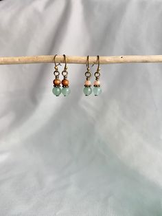 - Handcrafted dangle earrings; each earring is truly one of a kind! - Antique bronze brass earring hooks - Beads topped with wrapped wire to add a more polished look and to make the loop very secure - Small green aventurine bead with either a wood bead or pink bead  - Dress up or wear casually - Make a great gift! - Earrings ship secured to jewelry cardboard and in a small bag and are placed in a padded shipping envelope.  - If earrings are marked as a gift, they will ship in a small jewelry box Small Beaded Earrings, Earrings Bronze, Small Dangle Earrings, Multiple Earrings, Dangle Earrings Boho, Bronze Earrings, Small Jewelry Box, Earrings Green, Pink Beads