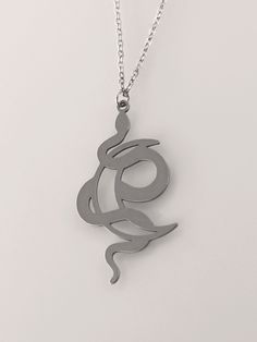 This Crescent Moon Snake Necklace is the perfect way to show your unique style. Featuring a crescent moon and serpent design, this striking piece of occult jewelry will make the perfect statement. Add a hint of mystery and allure to your look with this gorgeous crescent moon snake necklace. You'll feel confident and powerful wearing this one of a kind piece of jewelry. With its unique and intricate design, you'll stand out from the crowd and showcase your individual style. Get ready to take your Spiritual Metal Jewelry In Snake Shape, Spiritual Snake-shaped Metal Jewelry, Black Symbolic Moon Phase Necklace, Engraved Metal Snake-shaped Jewelry, Black Symbolic Jewelry With Moon Charm, Symbolic Black Necklace With Moon Charm, Elegant Black Snake-shaped Jewelry, Black Snake-shaped Necklaces As Gift, Black Snake Shape Necklace Gift