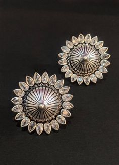 Add charm and charisma to your beautiful personality with these exquisitely designed and handcrafted German silver earrings studded with high quality AD stones.Pair them up with any casual or formal attire and gather compliments for your unique choice.Each earring weighs 10 GM's Length 1.2 inches approxWidth 1.2 inches approx********************************Note: All in stock items will be shipped from New Delhi, India within 2-3 business days after receipt of payment. International orders may ta Dual-tone Sterling Silver Round Jewelry, Ornate Silver Dual-tone Jewelry, Silver Fusion Jewelry With American Diamond, Ornate Silver Kundan Jewelry, Silver Dual-tone Round Jewelry, Silver Temple Jewelry Earrings For Festivals, Handmade Silver Fusion Style Jhumkas, Ornate Dual-tone Earrings As Gift, Ornate Silver Kundan Earrings