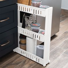 a white shelf holding spices and other kitchen items