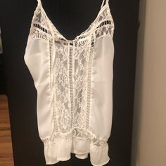 White Lace Tank. Never Worn. Has See Through Lace Going Down Center. Can Be Worn Alone Or With Cami. White V-neck Camisole For Vacation, White Summer Camisole For Vacation, Elegant Lace Camisole For Beach, White Lace Tank Top For Day Out, Summer Lace Top Camisole For Vacation, Summer White Lace Camisole, Chic Lace Top Camisole For Vacation, Chic White Lace Tank Top, White Lace Summer Camisole