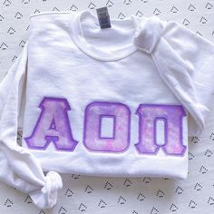 This unique, handcrafted Pink & Purple Cloud Marble Greek Letter Gildan Crew Neck Sweatshirt is sure to stand out on any campus!  Grab one for you, your favorite sister, or a group of sisters (chapter discounts offered - see below for more information).Pictures Featuring: 1-5. White sweatshirt w/ light purple background fabric color There are 4 parts to your Greek Letter Sweatshirt:1. Sweatshirt Color2. Sweatshirt Size3. Background Fabric Letter Color- This is the fabric behind the printed f Sorority Letters Sweatshirt, Sorority Shirts Letters, Sweatshirt Inspiration, Greek Letter Shirts, Light Purple Background, Letter Hoodie, Sorority Sweatshirts, Letter Sweatshirt, Sorority Letters