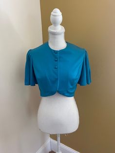 Fun vintage 70's bolero/capelet, very disco. Would be super cut over a dress, or as a crop top with high waisted jeans. Bust 38" Top to bottom 15" Fitted Blouse With Cape Sleeves For Party, Cropped Fitted Shrug For Party, Fitted Cape Sleeves Blouse For Party, Fitted Tops With Cape Sleeves, Fitted Cropped Party Blouse, Cropped Fitted Blouse For Party, Fitted Cropped Blouse For Party, Fitted Evening Blouse With Cape Sleeves, Fitted Turquoise Top For Fall