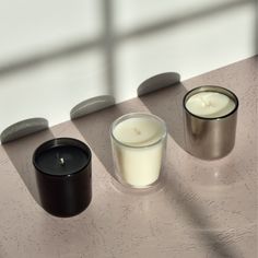 three candles sitting next to each other on a table