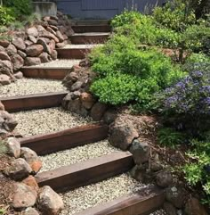 there are many steps made out of rocks and gravel in the garden, along with flowers