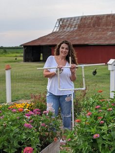 a woman standing in front of a garden