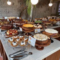 an assortment of pies and pastries on display at a buffet table in a restaurant