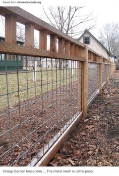 the fence is made of wood and has metal bars on each side, along with leaves