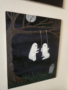 two ghost paintings hanging on the wall next to each other