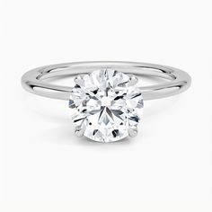 a round brilliant cut diamond engagement ring in 18k white gold on a plain band