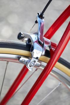 the front brake of a red bicycle