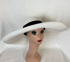 This white Toyo straw 6-inch brim sun hat has a flat brim and black ribbon band.  The hat is great for any event and packable with excellent UV protection. The hat comes in medium and large head sizes and has an inside sizing cord to adjust to your head size. The medium fits 22 - 22.5 inch head size. The large will fit 59cm 22.5- 23 1/4-inch head size NOTE: Please check the head size before purchase, I am happy to answer any questions you may have. There will be a 20% restocking fee for all retu Fitted White Fedora Sun Hat, White Fitted Fedora Sun Hat, Elegant White Hat Bands For Vacation, Classic White Wide Brim Sun Hat, Adjustable White Boater Hat With Curved Brim, White Adjustable Boater Hat With Curved Brim, White Fedora Sun Hat For Kentucky Derby, Adjustable White Boater Hat, White Fitted Hat Bands For The Beach