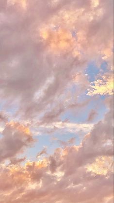 the airplane is flying high in the sky with clouds above it and another plane on the ground below