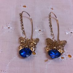 These beautiful pieces are Goldtone Wire Pierced Earrings with Clear Rhinestones Accenting the Goldtone Wires and a Goldtone Filigree Butterfly Drop with a Cobalt Blue Glass Crystal. No maker's mark found. Used but in great condition. Dimensions of the Earrings is approximately 1 3/4 inches by 5/8 inches. Blue Metal Earrings With Rhinestones, Blue Jeweled Metal Earrings, Blue Rhinestone Drop Earrings, Maker's Mark, Glass Crystal, Pierced Earrings, Clear Rhinestones, Blue Crystals, Earings Piercings