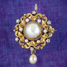 A beautiful little antique Victorian pendant/ brooch depicting a leafy, 18ct gold wreath, surrounding a large natural pearl in the centre. It has a lovely lustre and is complemented by a halo of twinkling old mine cut diamonds and smaller pearls, with a pearl dropper hanging from the bottom.   Pearls are a true treasure of the ocean, desired throughout history for their rich, creamy tone and exceptional lustre that is produced organically by fresh and saltwater molluscs. They've become symbolic Pearl Diamond Pendant, Gold Wreath, Victorian Pendants, Pendant Brooch, Ancient Jewelry, Natural Pearl, Pearl Diamond, Antique Rings, Natural Pearls