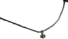 a necklace with a green heart on it