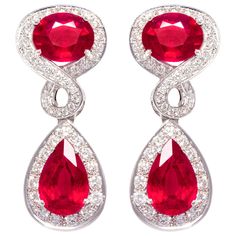 The ruby and diamond earrings feature 4 faceted African rubies of homogeneous brilliance for a total of 21.50 carats. The elegant design is complete with 2.70 carats of round diamonds of top quality (F-G/VVS). The earrings are flexible just to the right extent. They were entirely hand made in 18 carat gold by maestro Scalabri in our own workshop in Italy according to an original design by Ella Gafter. They are signed EG. Ruby And Diamond Earrings, White Gold Drop Earrings, Ruby Jewellery, Fantasy Earrings, Vintage Drop Earrings, Bling Earrings, Sparkly Jewelry, Holly Berry, Earrings Design