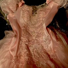 the dress is pink and gold in color