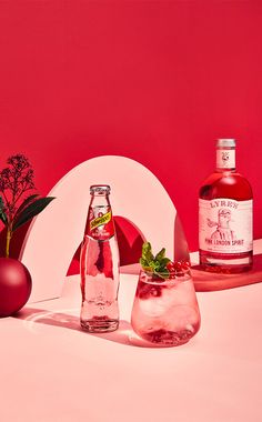 two bottles of alcohol sitting next to each other on a table