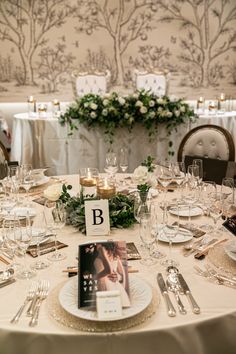 the table is set with silverware and place settings