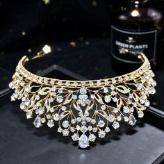 Up your sparkle factor with this romantic tiara design that can complete the most sophisticated of bridal looks. Intricately faceted cubic zirconia work their way across the band and capture the light from every angle with a perfectly translucent appeal. Cast in lightweight alloy and silver/yellow gold/rose gold plated for a flawless finish, the headband measures 2.5" at the tallest point (approx. 6.3cm) and 6" in diameter (approx. 15cm). Two small loops at each end make it easy to attach to you Luxury Adjustable Wedding Headpieces, Luxury Adjustable Headpieces For Weddings, Gold Cubic Zirconia Bridal Accessories For Wedding, Elegant Gold Bridal Accessories With Cubic Zirconia, Sparkling Cubic Zirconia Wedding Rings, Glamorous Rhinestone Wedding Headpiece, Elegant Crystal Headpieces For Weddings, Glamorous Wedding Headpiece With Rhinestones, Glamorous Rhinestone Headpiece For Wedding