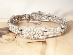 "Offering an EXQUISITE. exceptional very sparkly pave rhinestone encrusted 1920s to 1930s era Art Deco Flapper link bracelet perfect for the bride! I truly believe this is an early French designer, \"Alfred Philippe \" bracelet. (If not, it is of equal or better quality!) I have seen a lot of Art Deco pave rhinestone bracelets in my time and this one just exude quality. Bracelet features four lacy ornate open work silver pot metal links that are pave set with tiny BRILLIANTLY clear sparkly cryst 1920s Great Gatsby, Rhinestone Bracelets, Early French, Vintage Rhinestone Jewelry, Art Deco Bracelet, Gatsby Wedding, French Designer, 1930s Art Deco, Something Old