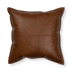 a brown leather pillow on a white background