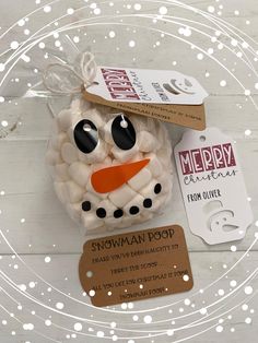 a snowman ornament with a tag attached to it