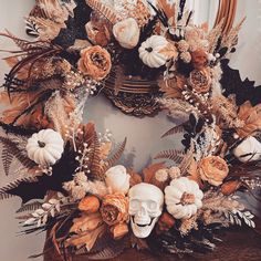 a wreath decorated with dried flowers and skulls