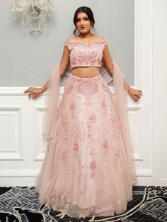 Farah Lehenga is a beautiful ensemble in an eternal blush pink, elevating the bride's attire. The scrupulous embroidery and glint of mirrors and resplendent pearls and glittering stone make it classy and sumptuous. Stitched with soft net fabric, it is inclusive of embroidered dupatta and blouse and lehenga that gives an ultimate, refined and royal look to the bride-to-be at her special occasion. Ideal for weddings and other exclusive events. Key Features: Color: Blush Pink Fabric: Soft net Embel Elegant Semi-stitched Lehenga With Pearl Embroidery, Elegant Floor-length Lehenga With Pearl Embroidery, Glamorous Hand Embellished Lehenga For Wedding, Glamorous Wedding Lehenga Hand Embellished, Glamorous Wedding Lehenga With Pearl Embroidery, Glamorous Wedding Sets With Resham Embroidery, Glamorous Hand Embellished Wedding Sets, Glamorous Wedding Sets With Pearl Embroidery, Elegant Floor-length Pearl Embroidered Choli