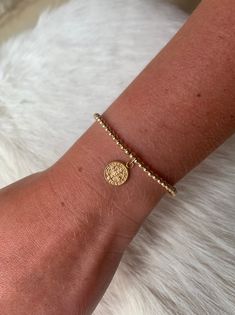 "This 14k gold filled bead bracelet is a perfect addition to a dainty stack. It is made of 3 mm 14K gold filled beads and is adorned with a 14K gold filled St. Benedict charm. The charm measures 11mm in diameter. For best fit, measure your wrist at the wrist bone with a measuring tape or string. Add 1/2\" to that measurement for a snug fit, 3/4\" - 1\" for a comfort fit, or 1\" or larger for a loose fit. Your bracelet will arrive in a gift box. Deluxe gift wrap is available at checkout. Listing Beaded 14k Gold Filled Yellow Gold Bracelets, Minimalist Hand-strung Beaded Bracelets In 14k Gold Filled, Minimalist Hand-strung 14k Gold Filled Beaded Bracelets, Dainty Yellow Gold Beaded Bracelets In 14k Gold Filled, Gold Delicate Stackable Beaded Bracelets, 14k Yellow Gold Filled Jubilee Beaded Bracelets, Delicate Gold Stackable Beaded Bracelets, 14k Gold-filled Yellow Gold Jubilee Beaded Bracelets, Dainty Gold Beaded Bracelets With Tiny Beads