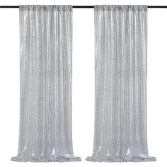 two silver curtains hanging on a metal rod