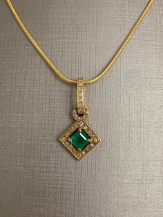 Princess Square Cut Emerald and Round Brilliant Diamond 18 Karat Yellow Gold Pendant Necklace with 18K Yellow Snake Rope Chain For Ladies 18 inch chain length 9.4 grams Elegant Gold Emerald Necklace With Diamond Cut, Exquisite Gold Pendant Emerald Necklace, Exquisite Gold Emerald Pendant Necklace, Formal Gold Emerald Necklace With Diamond Cut, Classic Gold Emerald Necklace With Diamond Cut, Yellow Gold Emerald Pendant Necklace With Diamond Cut, Fine Jewelry Emerald Necklace With Square Yellow Gold Pendant, Exquisite Hallmarked Emerald Necklace In Yellow Gold, Gold Emerald Pendant Necklace With Hallmark