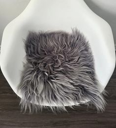 a white chair with grey fur on it