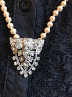 "I love this combination so I decided to sell them together. Beautiful strand of faux hand knotted pearls stamped Japan and 24\" Long. I have added the stunning Vintage Dress Clip with beautiful clear bezel set rhinestones in a shield shape. Very flattering to the neck. You can wear the pearls Alone or with the clip. You can wear the clip on a collar, a dress, Jacket, in your hair or on a purse. The pearls are a beautiful soft Creamy shade with an  Almost rose hint to them." Vintage Dress Clips, Elegant Beaded Pearl Rhinestone Necklace, Elegant Rhinestone Necklace For Vintage Events, Elegant Pearl And Beaded Rhinestone Necklace, Elegant Pearl And Rhinestone Beaded Necklace, Vintage Pearl Necklaces With Rhinestones, Formal Beaded Pearl Rhinestone Necklace, Formal Pearl Necklace With Rhinestones, Elegant Pearl Necklace With Rhinestones For Formal Occasions