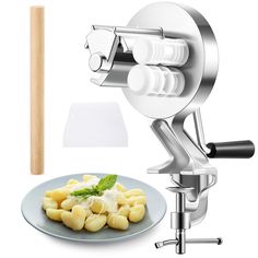 the pasta maker is next to a plate of food