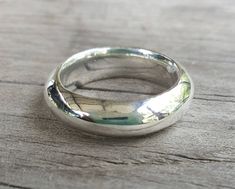 a silver ring sitting on top of a wooden table