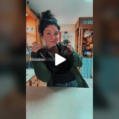 a woman standing in front of a kitchen counter