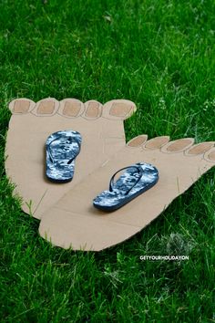 pair of flip flops laying on cardboard in the grass