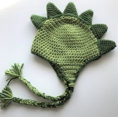 a crocheted hat with a green leaf on it